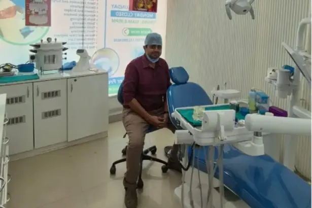 Dent O Touch dental clinic treatment room with dentist sitting near dental chair in a modern clinical setup